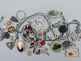 many different types of jewelry on a white surface