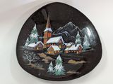 a plate with a picture of a church and trees on it