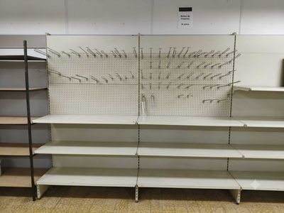 a empty shelf in a store with many empty shelves