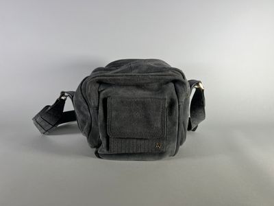 an image of a black camera bag sitting on top of a table