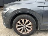 a close up of a car ' s tire on the road