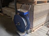 a machine that is sitting in front of a pile of wood