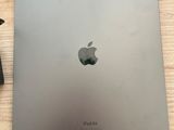 an apple laptop sitting on top of a wooden table next to a keyboard