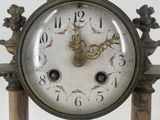 a clock that is sitting on top of a wooden stand