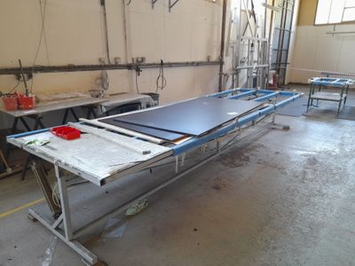 a table with a sheet of metal on it in a room