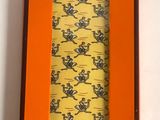 an orange box with a tie in it sitting on a white surface