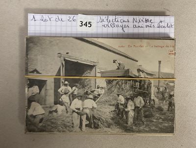 an old photo of a group of men loading hay onto a truck