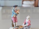 a figurine of a man and a woman sitting on a boat