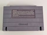 an old nintendo game console sitting on top of a white table