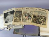 a lot of old french newspapers on a shelf