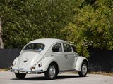 a white vw beetle parked in a parking lot