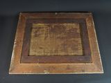an old wooden picture frame with a brown stain on it