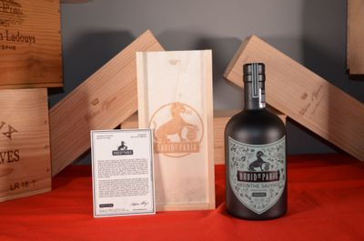 a bottle of wine sitting next to a box of wine