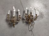 pair of crystal and brass sconces on a wall