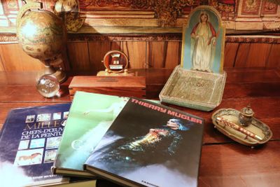 a table with books and a statue on it