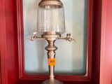 a lamp that is sitting on a shelf next to a picture frame