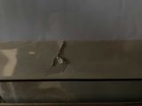 a broken laptop computer sitting on top of a wooden table