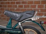 a motorcycle that is parked in front of a brick wall