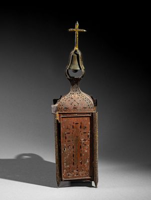 pair of antique brass lanterns with a bell and cross on top