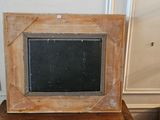 a picture frame sitting on top of a wooden table