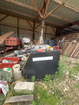 a pile of junk in a building with a roof