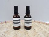 two bottles of liquid sitting on top of a woven basket