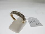 gros plan d'une bague sur une surface blanche avec une étiquette de prix