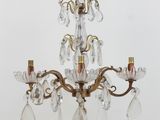 a small crystal chandelier on a table with a light on it