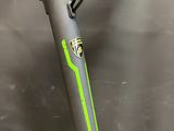 a close up of a bike with a green handlebar