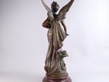 an image of a statue of an angel holding a flower