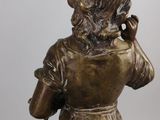bronze statue of a woman talking on a cell phone