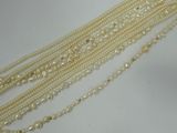 a close up of a row of pearls on a white surface