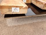 two pieces of wood are stacked on top of each other on the ground
