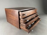 an image of a wooden drawer with four drawers