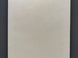 blank paper hanging on the wall in a dark room
