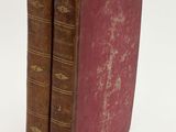 pair of antique leather bound books on white background