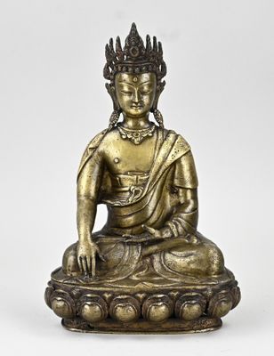 a bronze figure of a buddha sitting on a lotus