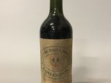 a bottle of wine sitting on top of a white table
