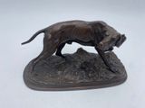 statue d'un chien posé sur un rocher, sur fond blanc