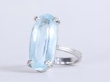 a close up of a ring with a blue topazt stone