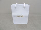 a white bag with the word dior on it sitting on a table