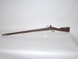 an old gun on a white table with a white background