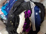 a pile of clothes in a basket on the floor