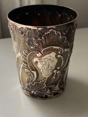 a silver cup that is sitting on a table