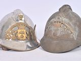 two helmets that are sitting side by side on a white surface
