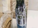 a water bottle with a picture of a forest on it