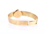 bracelet with a gold plated metal band and a round clasp
