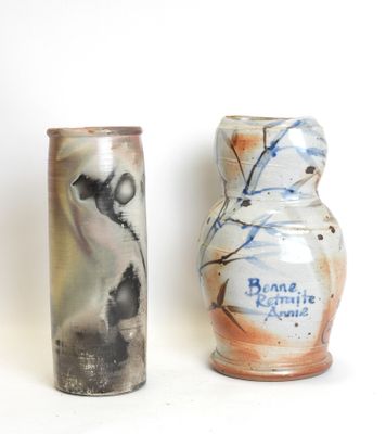 two vases sitting next to each other on a white surface