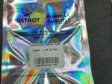 a bag of marijuana sitting on a table next to a packet of cigarettes