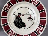 a picture of a plate with a picture of a man and a dog
